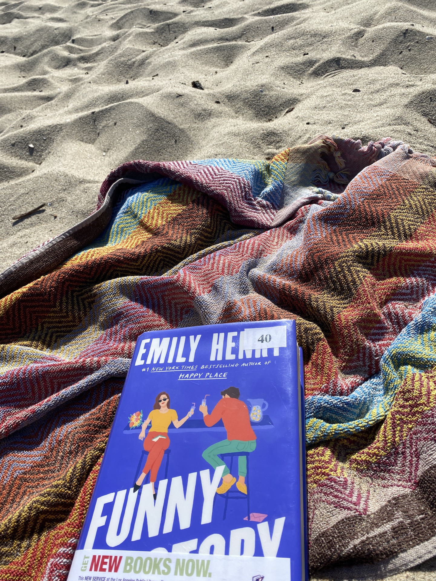 Funny Story book on a beach towel in the sand