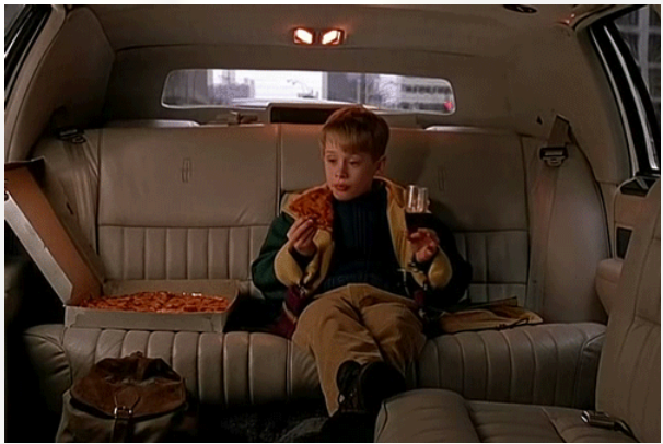 Movie still of Kevin McAllister enjoying pizza in a limo 